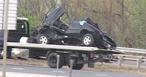 A mangled vehicle is towed away from the scene of a fatal I-80 crash on Sunday in Joliet. | Network Video Productions