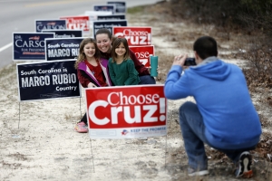 John Mew, right, photographs his wife Amy, and daughters Ireland, 6, left, and Sailor, 4, after voting in the South Carolina Republican presidential primary Saturday, Feb. 20, 2016, at Emmanuel Lutheran Church in West Columbia, S.C. (AP Photo/Matt Rourke)
