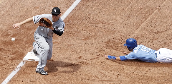 Kansas City Royals' Whit Merrifield (15) beats the tag by Chicago White Sox third baseman Todd Frazier to steal third base during the third inning of a baseball game Saturday, May 28, 2016, in Kansas City, Mo. (AP Photo/Charlie Riedel)